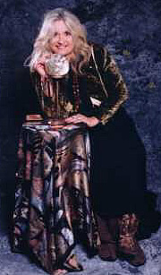 photo of Share Starwas standing next to her crystal ball and decks of tarot cards